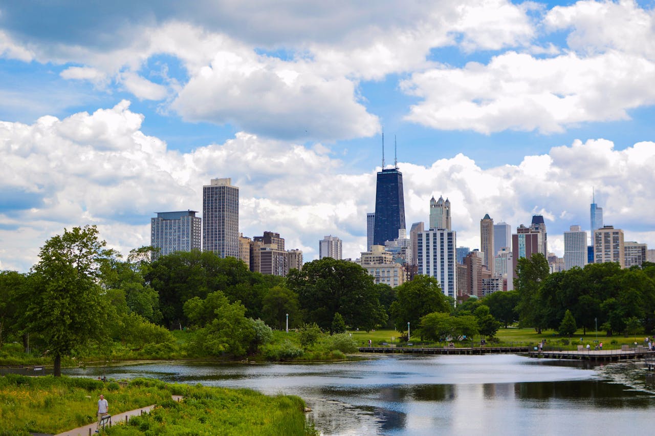 hero-gallery-01 View of Chicago skyline and lake from Lincoln Park with lush greenery and blue skies.